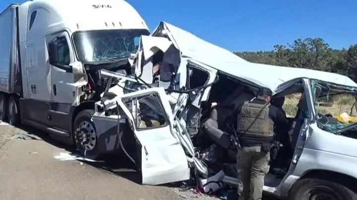 The band's van crushed against the front of an 18-wheeler on a New Mexico highway, with a sheriff's deputy at the scene
