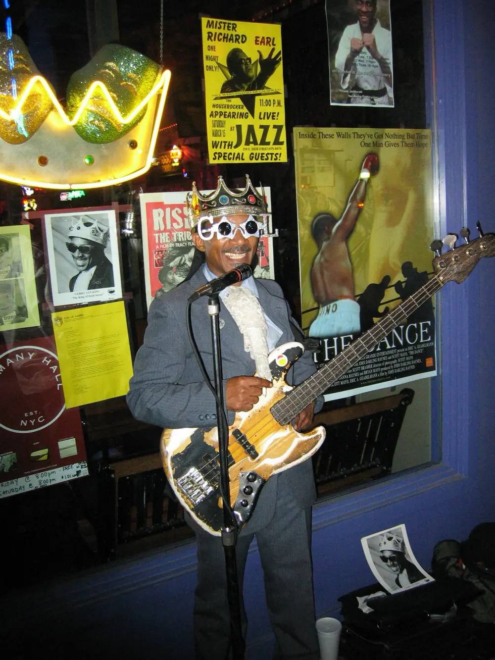 Gerry Van King in his crown and shades, playing bass outside Jazz on Sixth Street, March 2014
