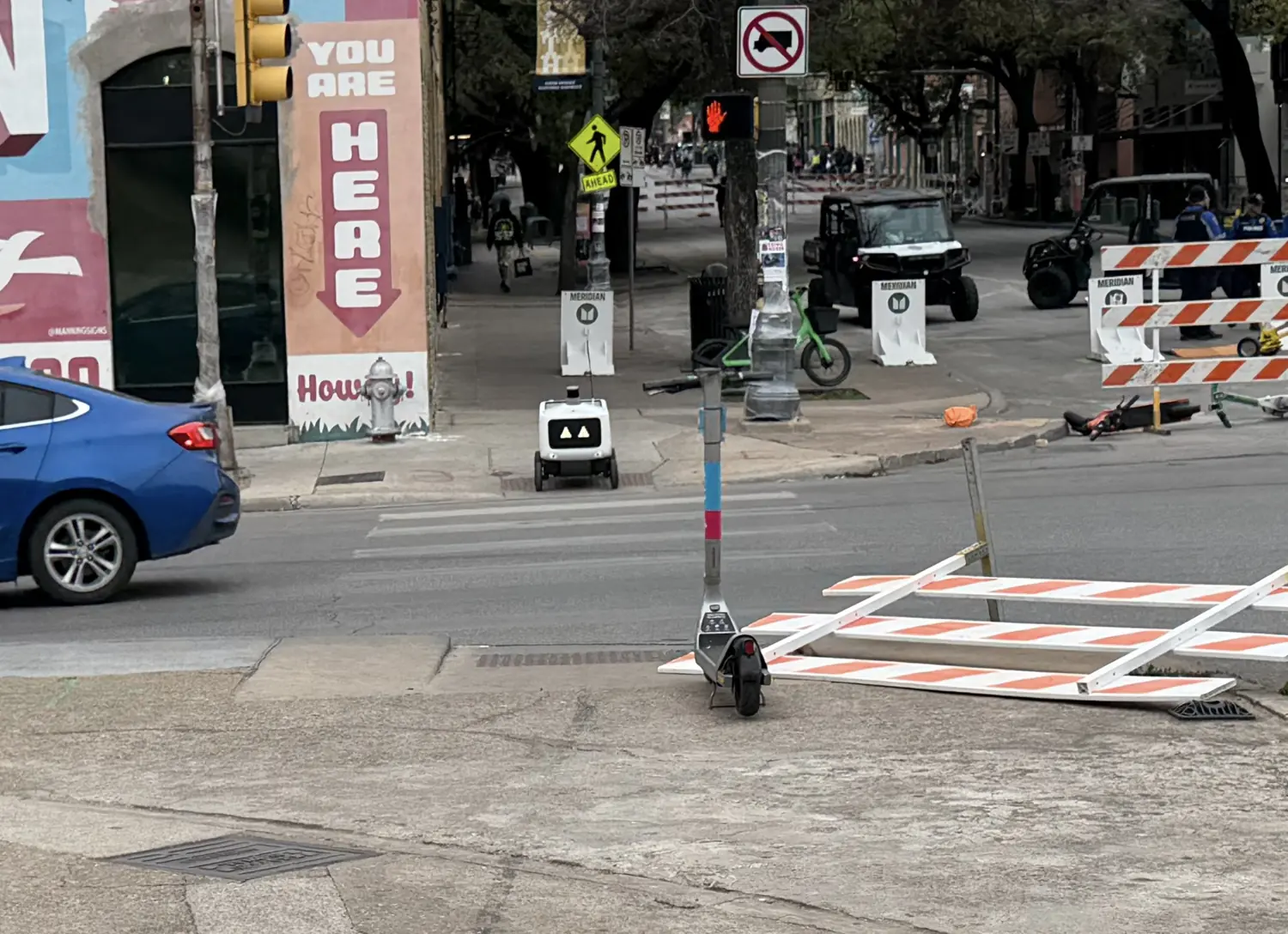 Robot waiting to cross IH-35 feeder road in Austin